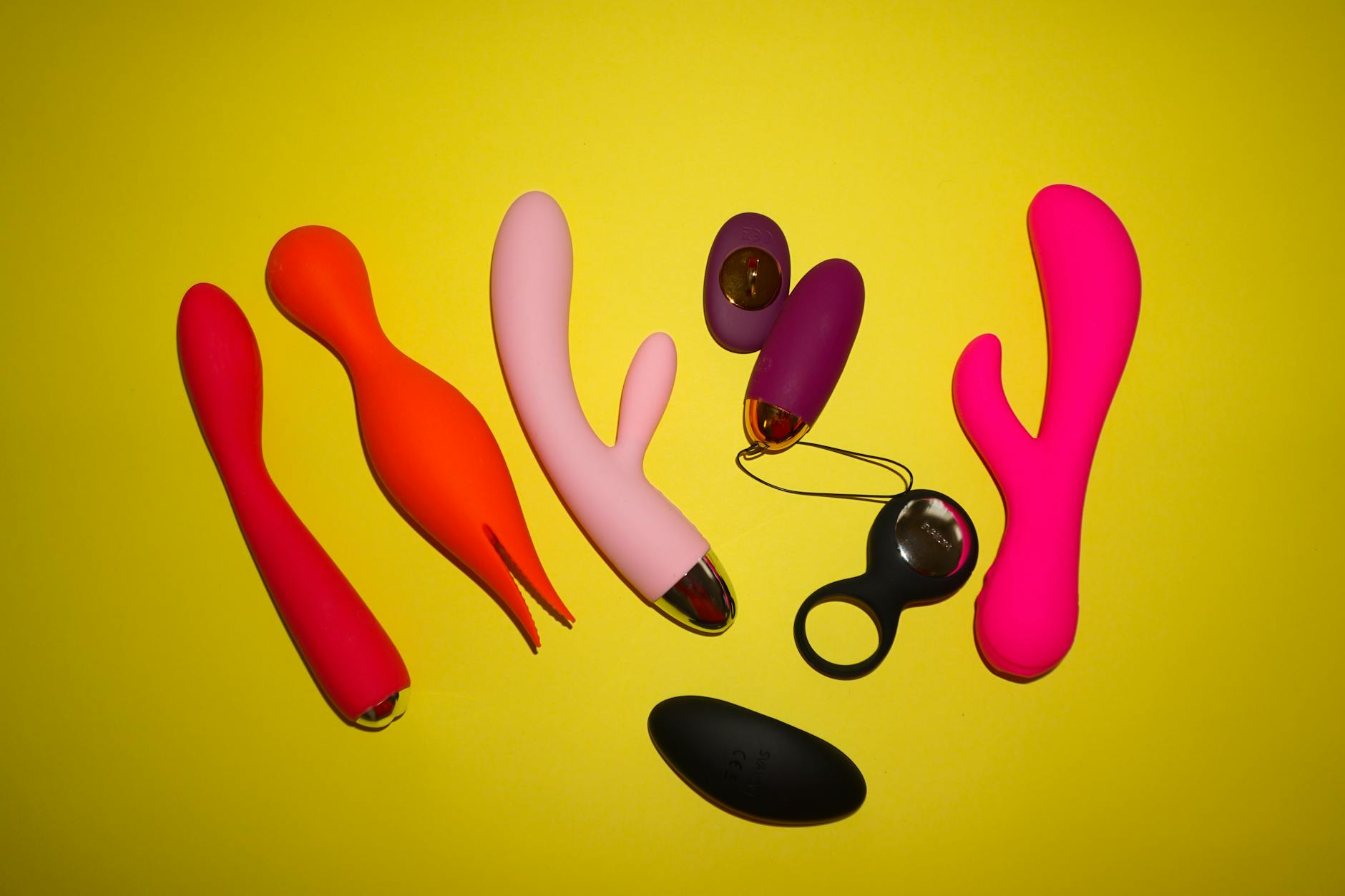 Hands holding colorful silicone toys together, symbolizing couples exploring pleasure on their own timeline