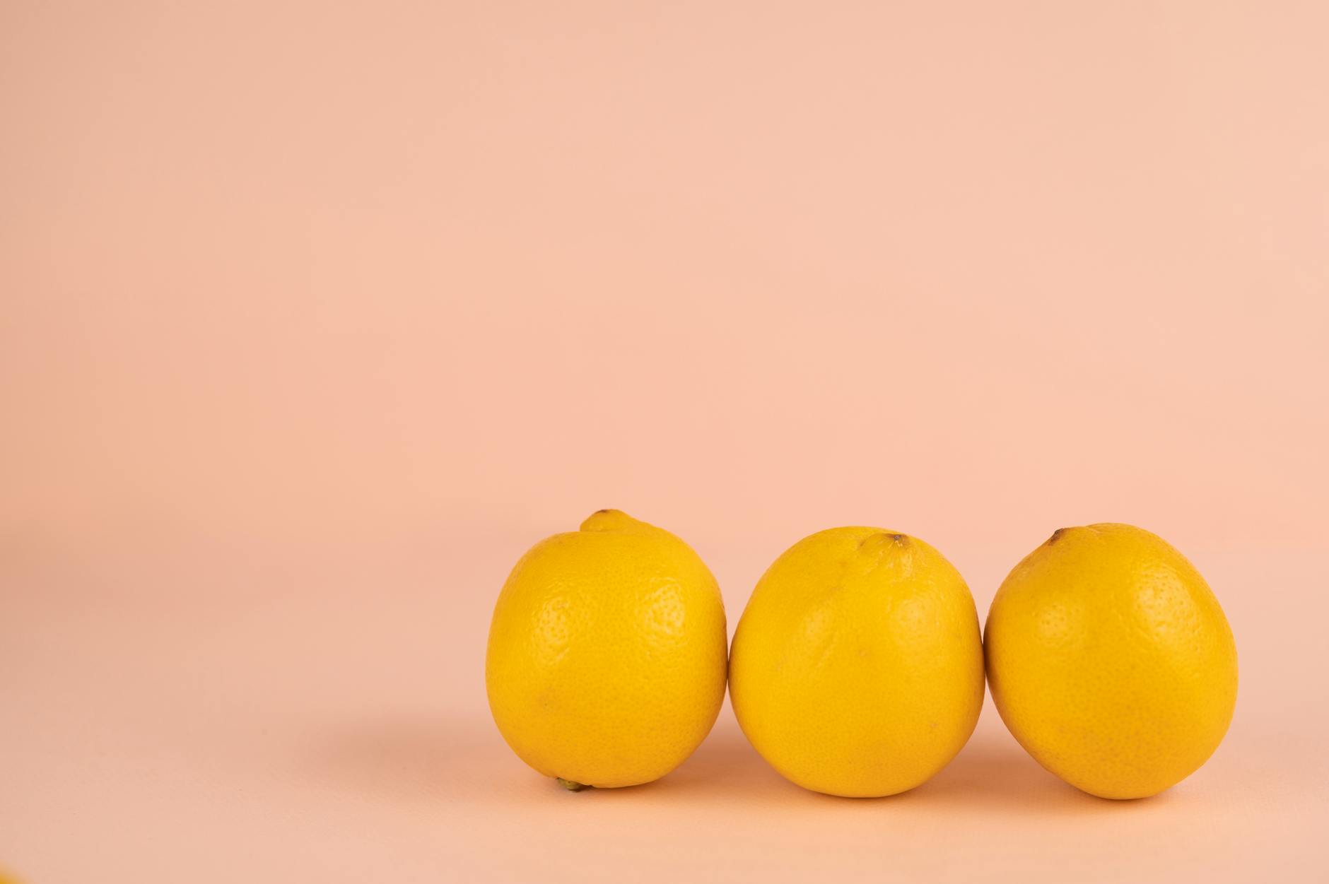Fresh yellow lemons on a pastel background, symbolizing natural pleasure and calm