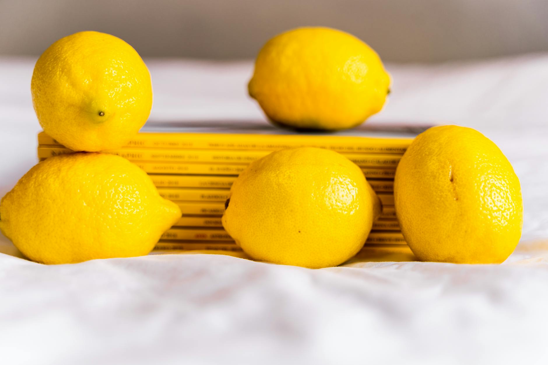 Hands holding fresh lemons on a brown surface, symbolizing privacy and personal care